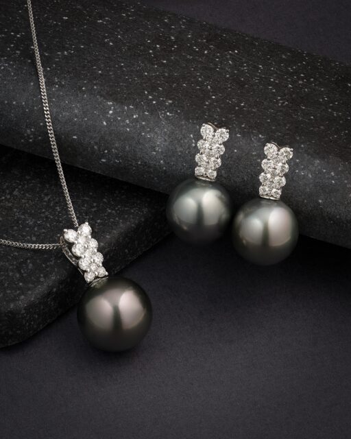 A striking combination of Tahitian pearl and diamond jewellery, crafted in 18ct white gold.
 
The earrings and matching pendant feature beautifully matched 12mm Tahitian cultured pearls, contrasted by 0.81cts of brilliant-cut diamonds. The cool white gold and diamonds accentuate the deep, metallic overtones of the pearls, giving the set a particularly dramatic character.
 
Tahitian pearls are cultivated in the black-lipped Pinctada margaritifera oyster, with the cultivation process typically taking around 18–24 months. Their natural colour spectrum can be remarkably intense, ranging from charcoal and silver through to peacock green, aubergine and deep graphite.
 
Finding one exceptional Tahitian pearl is special; assembling pearls with closely matched size, shape, lustre and colour for earrings and complete sets is considerably rarer.
 
#FineJewellery #TahitianPearls #PearlJewellery #DiamondJewellery #LuxuryJewellery